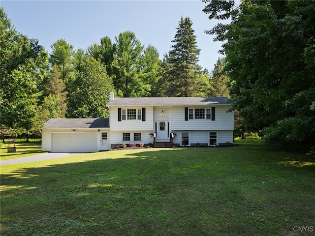 14496 Military Rd, Hounsfield, NY 13685 - split foyer home with concrete driveway, a garage, entry steps, a front yard, and a chimney