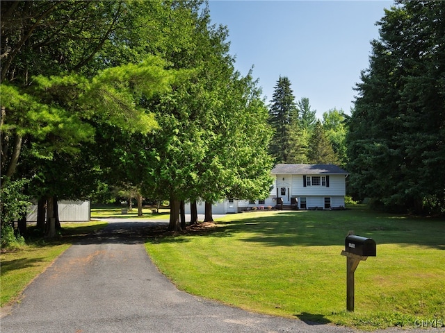 14496 Military Rd, Hounsfield, NY 13685 - bi-level home featuring asphalt driveway and a front lawn