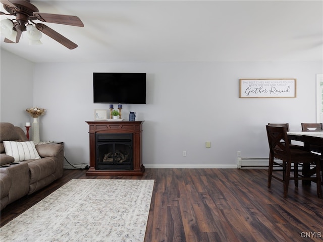 14496 Military Rd, Hounsfield, NY 13685 - living area with a baseboard radiator, ceiling fan, dark wood-type flooring, and a fireplace
