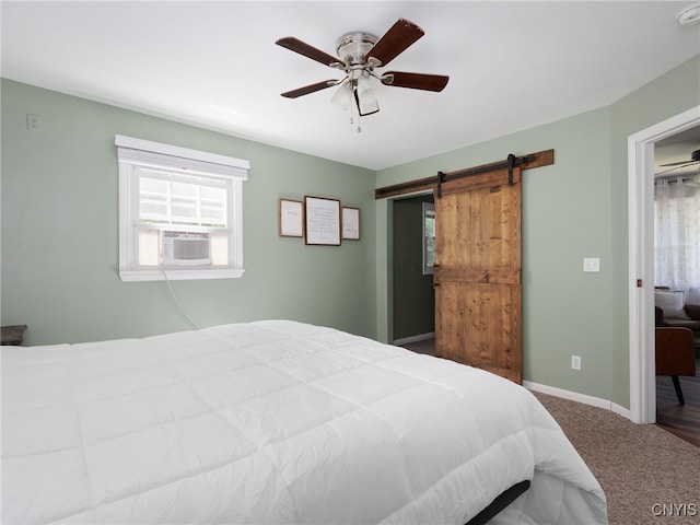 14496 Military Rd, Hounsfield, NY 13685 - carpeted bedroom with a barn door, a ceiling fan, and cooling unit