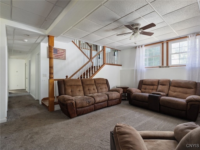 14496 Military Rd, Hounsfield, NY 13685 - living room featuring carpet, ceiling fan, stairway, and a paneled ceiling