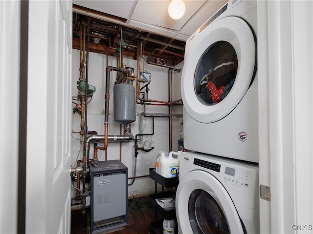 14496 Military Rd, Hounsfield, NY 13685 - washroom featuring stacked washing machine and dryer, a heating unit, and dark wood-style floors