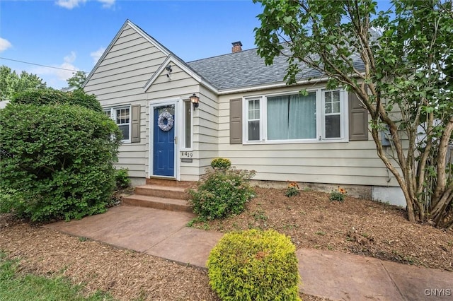 419 Bronson Rd, Geddes, NY 13219 - bungalow with entry steps, roof with shingles, and a chimney