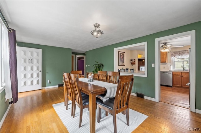 419 Bronson Rd, Geddes, NY 13219 - dining room featuring light wood-style floors and ceiling fan