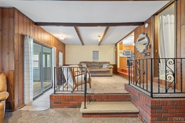 419 Bronson Rd, Geddes, NY 13219 - living area featuring carpet flooring, wooden walls, and beam ceiling