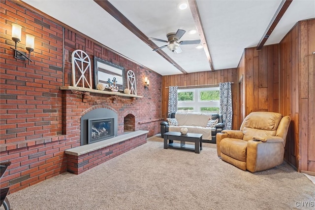419 Bronson Rd, Geddes, NY 13219 - carpeted living area with beamed ceiling, ceiling fan, a brick fireplace, wood walls, and brick wall