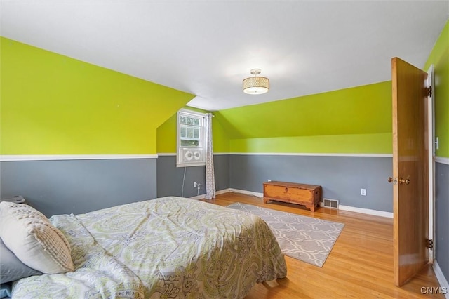 419 Bronson Rd, Geddes, NY 13219 - bedroom featuring wood finished floors and vaulted ceiling
