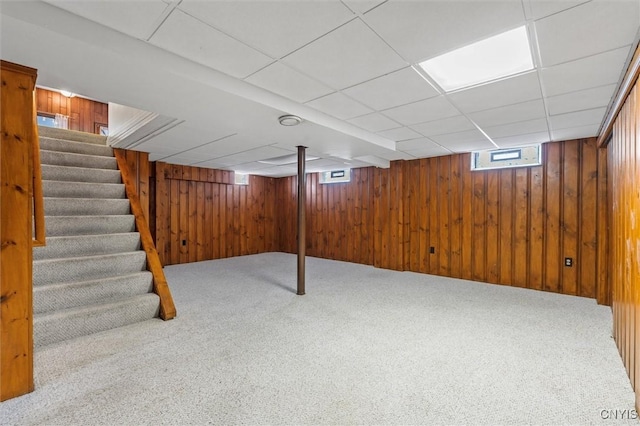 419 Bronson Rd, Geddes, NY 13219 - below grade area featuring carpet flooring, stairway, wooden walls, and a drop ceiling