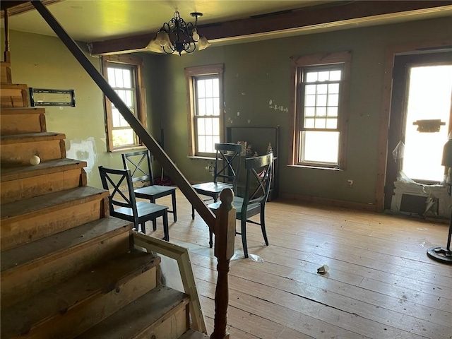 10276 Roosevelt Hwy, Yates, NY 14098 - dining room featuring stairway, light wood-type flooring, and a chandelier