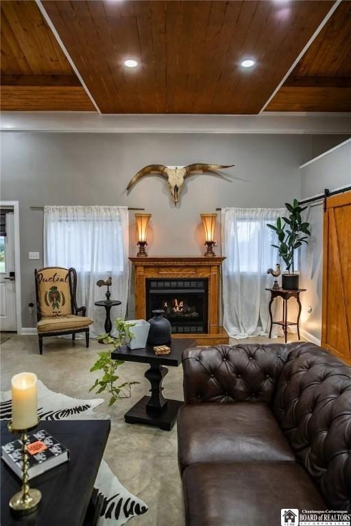 942 Spencer Rd, Kiantone, NY 14701 - living area with wooden ceiling, a warm lit fireplace, a barn door, and concrete flooring