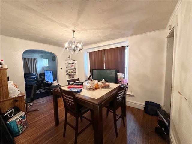 380 Sawyer St, Rochester, NY 14619 - dining area with arched walkways, dark wood finished floors, and a chandelier