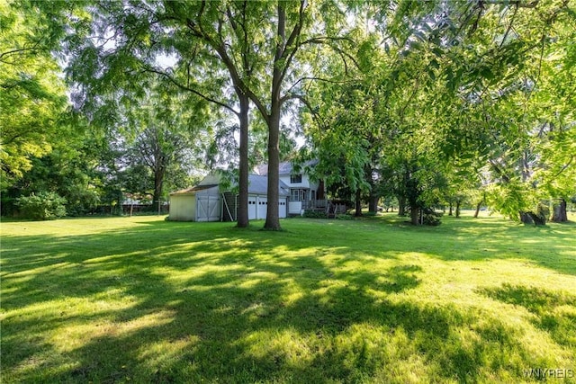 2458 Hess Rd, Newfane, NY 14008 - view of green lawn featuring a garage, an outdoor structure, and a barn