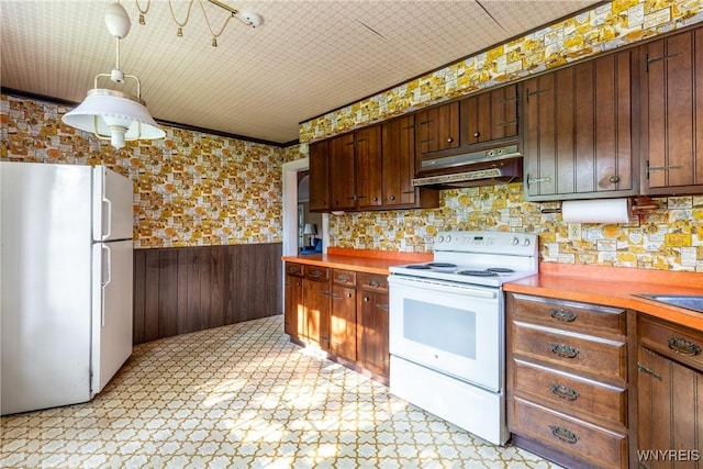 2458 Hess Rd, Newfane, NY 14008 - kitchen with white appliances, under cabinet range hood, a wainscoted wall, light floors, and light countertops
