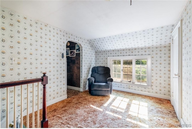 2458 Hess Rd, Newfane, NY 14008 - living area featuring wallpapered walls, arched walkways, carpet, and an upstairs landing