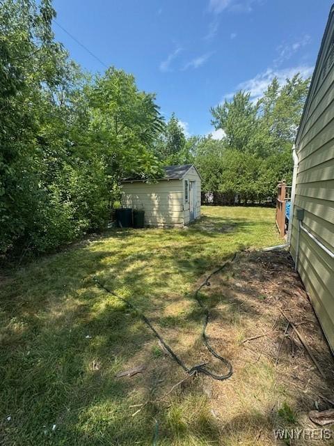 454 Campus Dr, Amherst, NY 14226 - view of grassy yard with a storage unit