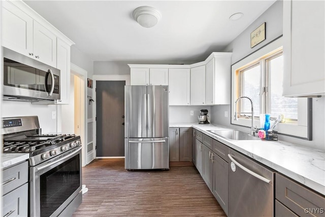 423 Highland Ave, Dewitt, NY 13057 - kitchen featuring stainless steel appliances, light countertops, wood finished floors, and white cabinetry