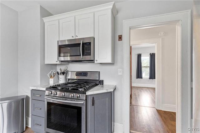 423 Highland Ave, Dewitt, NY 13057 - kitchen with appliances with stainless steel finishes, light wood finished floors, gray cabinets, and white cabinets