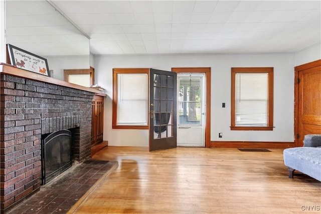 423 Highland Ave, Dewitt, NY 13057 - living room featuring wood finished floors and a brick fireplace