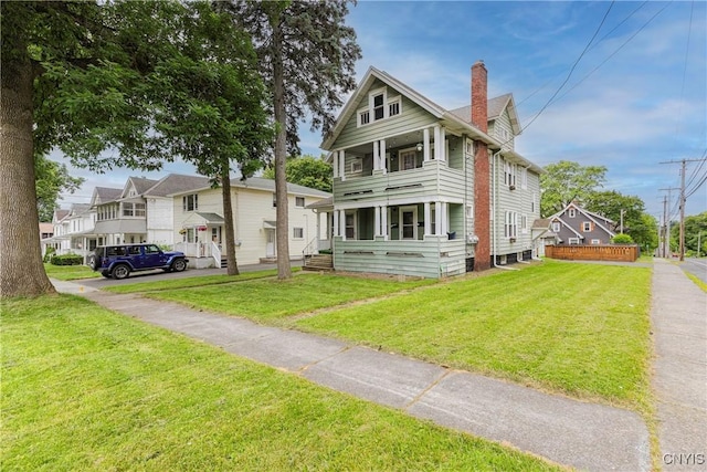 423 Highland Ave, Dewitt, NY 13057 - greek revival inspired property with a balcony, a chimney, and a front yard