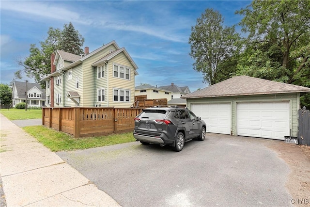 423 Highland Ave, Dewitt, NY 13057 - view of side of home with an outdoor structure, a detached garage, and a chimney