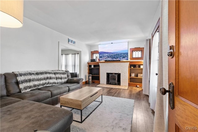 423 Highland Ave, Dewitt, NY 13057 - living room with hardwood / wood-style flooring, plenty of natural light, and a brick fireplace