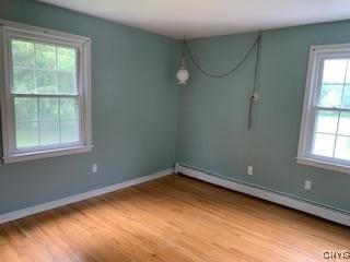 884 Kibby Rd, Lysander, NY 13027 - empty room featuring a baseboard radiator and light wood-style flooring