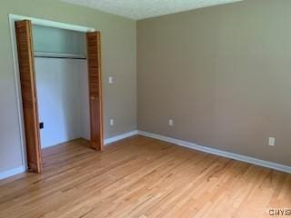 884 Kibby Rd, Lysander, NY 13027 - unfurnished bedroom with light wood-style floors and a closet