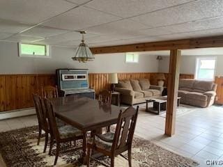 884 Kibby Rd, Lysander, NY 13027 - dining room featuring wooden walls, a drop ceiling, plenty of natural light, a wainscoted wall, and light tile patterned flooring