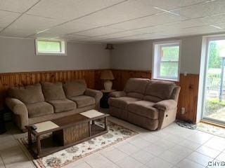 884 Kibby Rd, Lysander, NY 13027 - living room featuring a drop ceiling, wainscoting, tile patterned flooring, and wood walls