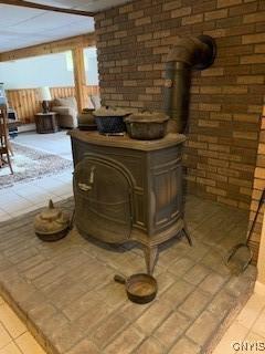 884 Kibby Rd, Lysander, NY 13027 - detailed view of a wood stove and brick wall