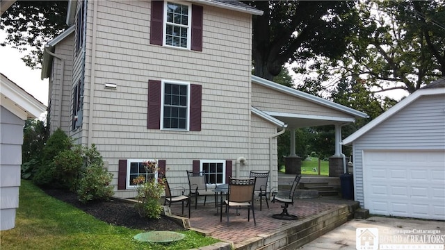 37 Center St, Ellery, NY 14712 - back of property with a garage and a patio area