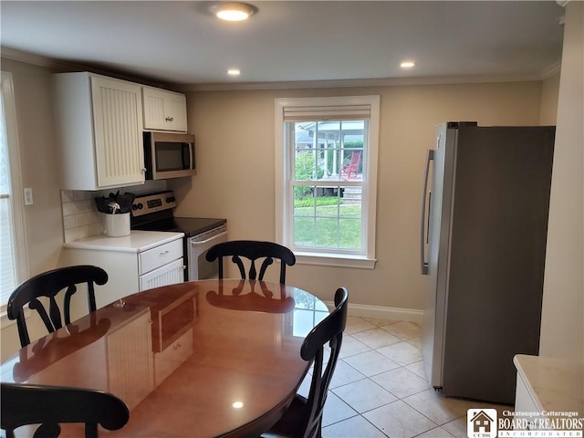 37 Center St, Ellery, NY 14712 - kitchen featuring appliances with stainless steel finishes, ornamental molding, light countertops, white cabinetry, and light tile patterned floors