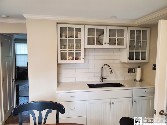 37 Center St, Ellery, NY 14712 - kitchen with light countertops, crown molding, decorative backsplash, glass insert cabinets, and white cabinets