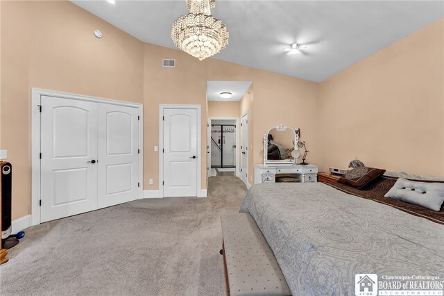 743 Legacy Dr Unit 209, Lewiston, NY 14092 - carpeted bedroom with a chandelier, a closet, and high vaulted ceiling