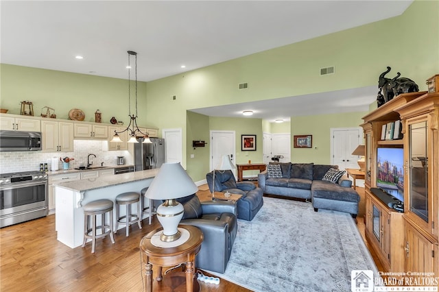 743 Legacy Dr Unit 209, Lewiston, NY 14092 - living room with high vaulted ceiling, light wood-type flooring, and recessed lighting