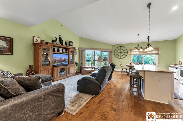743 Legacy Dr Unit 209, Lewiston, NY 14092 - living area featuring healthy amount of natural light, dark wood finished floors, and lofted ceiling