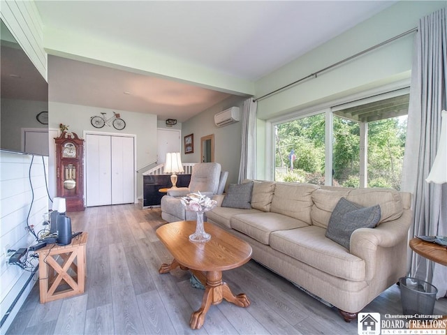 5301 E Lake Rd Unit 23, Chautauqua, NY 14728 - living room with a wall mounted air conditioner and wood finished floors