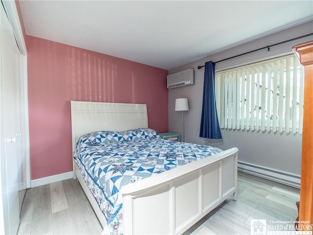 5301 E Lake Rd Unit 23, Chautauqua, NY 14728 - bedroom featuring a baseboard radiator, a wall mounted AC, and wood finished floors