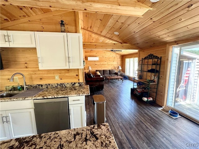 3018 Camp Rd, Eaton, NY 13334 - kitchen with stainless steel dishwasher, wooden walls, healthy amount of natural light, white cabinetry, and dark wood-style floors