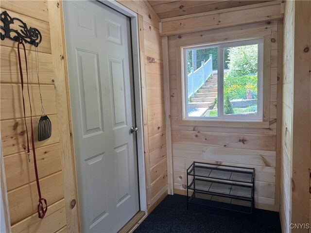 3018 Camp Rd, Eaton, NY 13334 - doorway to outside featuring wood walls