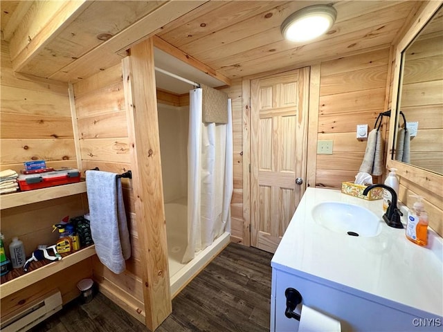 3018 Camp Rd, Eaton, NY 13334 - full bath featuring a baseboard heating unit, wood finished floors, wood walls, vanity, and a stall shower