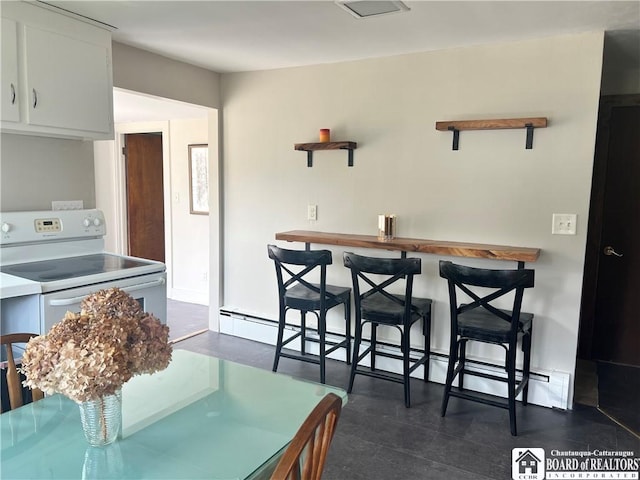 70 Williams Ave, Wellsville, NY 14895 - dining space with bar area and a baseboard heating unit