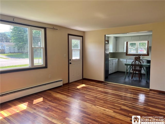 70 Williams Ave, Wellsville, NY 14895 - foyer entrance featuring baseboard heating and dark wood-style flooring
