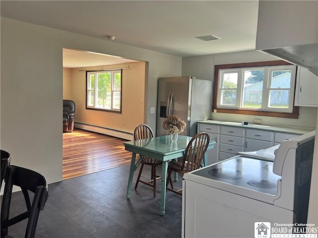 70 Williams Ave, Wellsville, NY 14895 - kitchen featuring a baseboard radiator, stainless steel fridge, white electric range, and light countertops