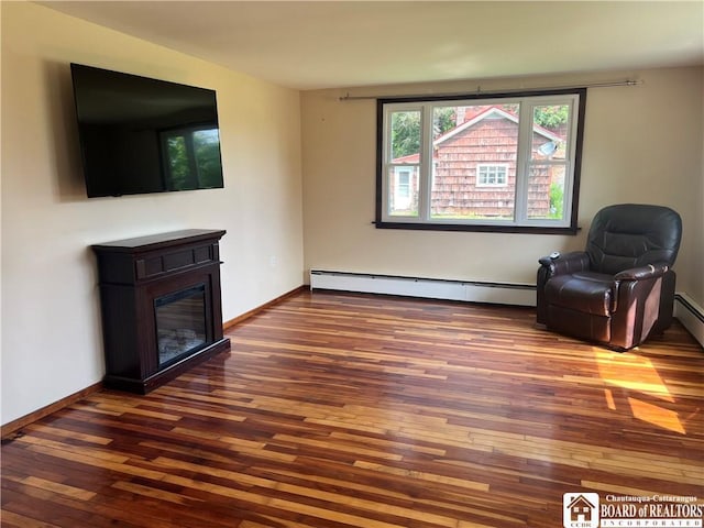 70 Williams Ave, Wellsville, NY 14895 - sitting room featuring a baseboard radiator, hardwood / wood-style floors, and a glass covered fireplace