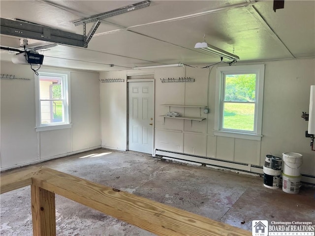 70 Williams Ave, Wellsville, NY 14895 - garage featuring a garage door opener and a baseboard radiator