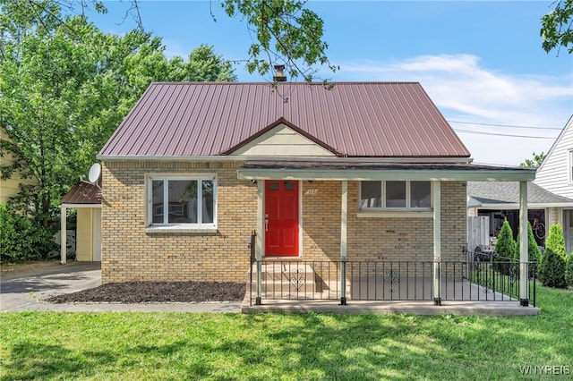 112 Southgate Rd, Cheektowaga, NY 14215 - view of front of property featuring brick siding, a front yard, and a metal roof