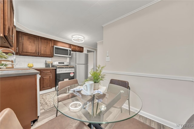 112 Southgate Rd, Cheektowaga, NY 14215 - dining room featuring light wood finished floors and ornamental molding