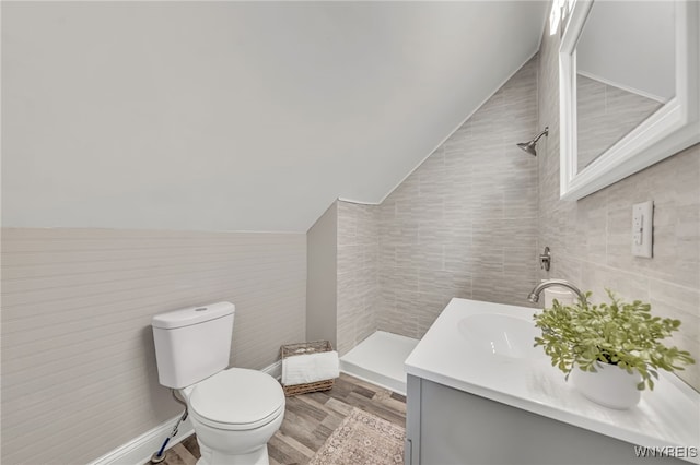 112 Southgate Rd, Cheektowaga, NY 14215 - bathroom with tile walls, vaulted ceiling, vanity, and wood finished floors
