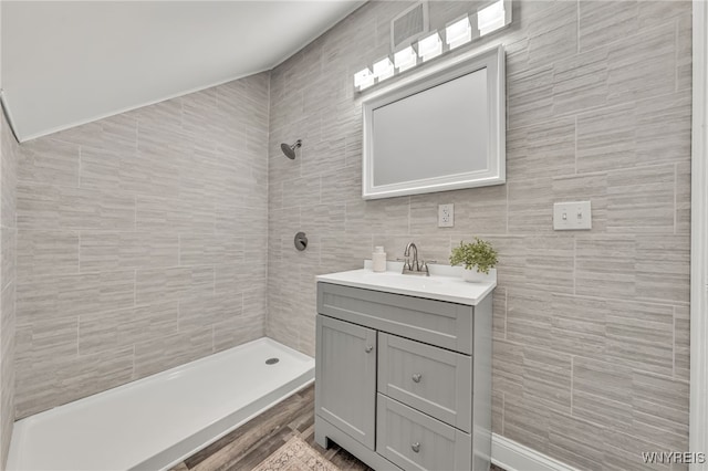 112 Southgate Rd, Cheektowaga, NY 14215 - bathroom featuring vanity, tiled shower, and tile walls